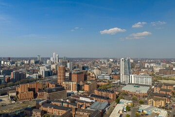 Obraz premium Aerial view of Leeds city centre in West Yorkshire showing Bridgewater Place modern buildings railway lines and dense urban development under a clear blue sky in the daytime in the spring season