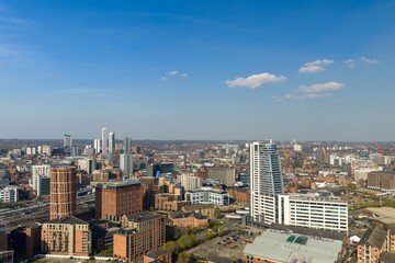 Fototapeta premium Aerial view of Leeds city centre in West Yorkshire showing Bridgewater Place modern buildings railway lines and dense urban development under a clear blue sky in the daytime in the spring season
