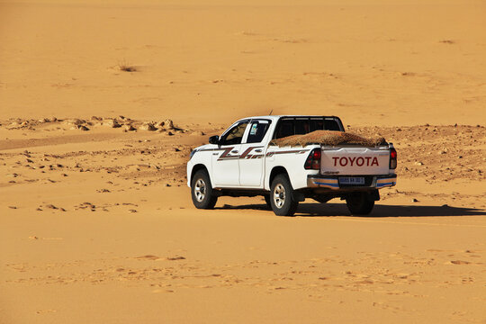 Chinguetti, Mauritania - 11 Jan 2022: Cars on sand dunes of Sahara Desert , Mauritania, West Africa