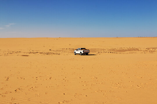 Chinguetti, Mauritania - 11 Jan 2022: Cars on sand dunes of Sahara Desert , Mauritania, West Africa