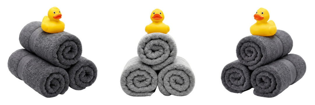 Three rolled gray towels with yellow rubber ducks on top isolated on transparent background
