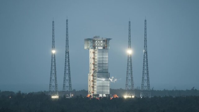 Night time-lapse of rocket launch tower and launch pad at Wenchang Satellite Launch Center, Hainan, China, aerospace industrial structure with lighting