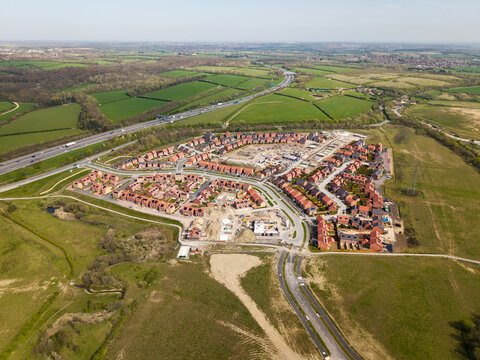 Aerial view of a new housing development creating a new community on green belt land in the UK countryside