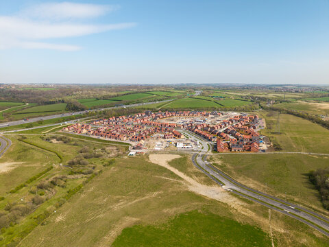 Aerial view above a new housing development on green belt land in the UK countryside