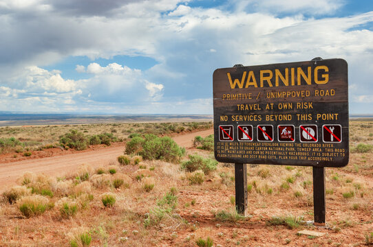 Warning sign declaring absence of services on the unpaved dirt road through the desert to Toroweap point in Grand Canyon national park, Utah, USA