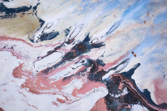 Aerial view of swirling hues of white, pink, brown, and blue creating an abstract earth painting, Salt Lake City, Utah, United States.