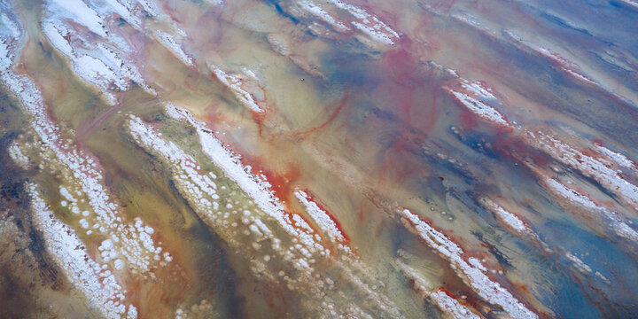 Aerial view of a tapestry of earthy hues interwoven with streaks of chalky white, resembling an abstract painting, Salt lake city, Utah, United States.