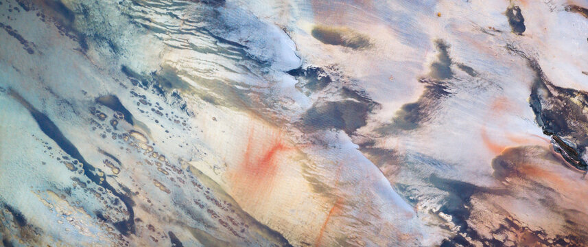 Aerial view of textured earth showing a mosaic of sandy, grey, and reddish tones creating an abstract yet natural landscape, Salt Lake City, Utah, United States.