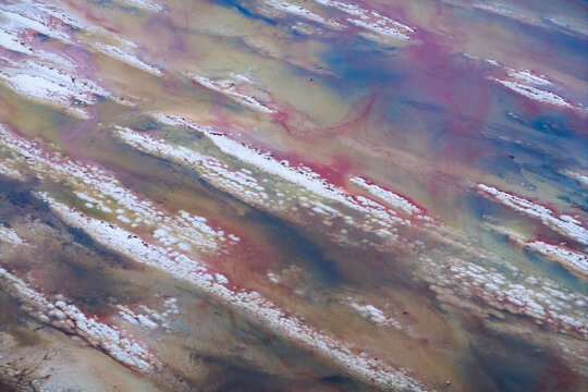 Aerial view of vibrant, swirling patterns of pink, white, blue and beige create an abstract landscape from above, Salt Lake City, Utah, United States.