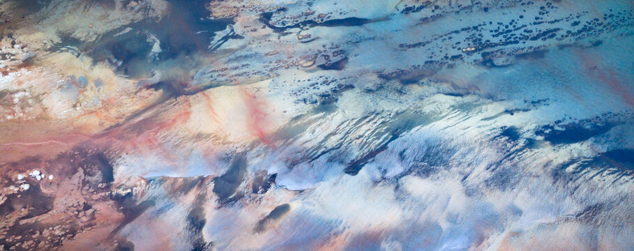 Aerial view of a mesmerizing blend of earth and sky, where rugged terrain meets swirling clouds, creating a symphony of textures, Salt Lake City, Utah, United States.