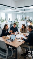Fototapeta premium Small Business Team Discussing Budget Around Conference Table, Laptop