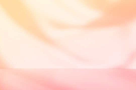 Abstract pastel color pink and orange gradient studio background with shadows of window. Empty 3d room. Display product with blurred backdrop.