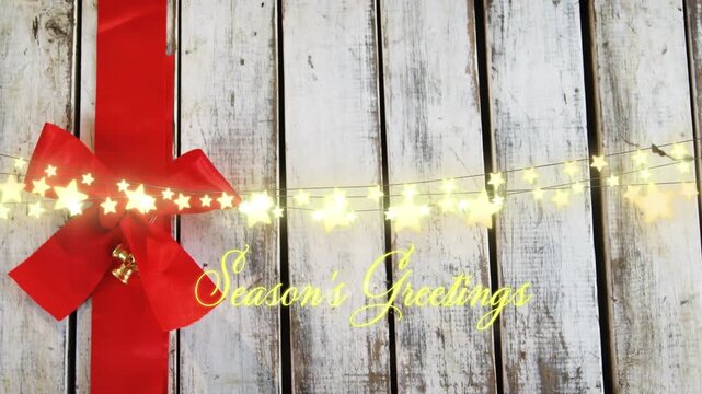 Animation of seasons greetings text over christmas tree decorations