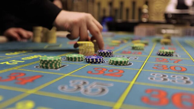 Casino Dealer Dealing Cards at Poker Table with Chips