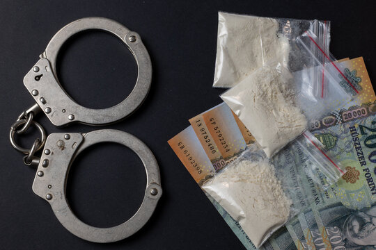Hungarian forint with drugs and handcuffs concept