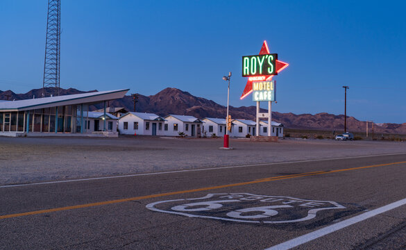 Amboy, United States - 07 April 2026: Roy's Motel and Cafe's vibrant neon lights at dusk, near the historic Route 66 landmark.