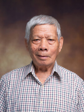 Elderly Asian Man Portrait on Neutral Background