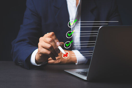 Businessman checking checklist with laptop