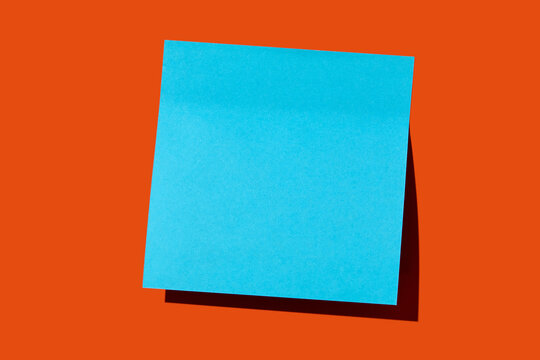 Blank blue post it note on orange background