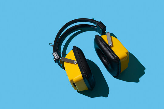 Vintage headphones on blue background