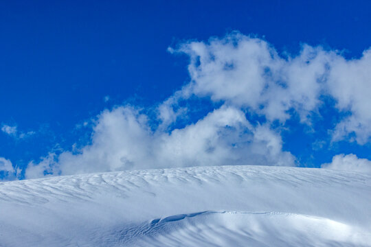 White clouds above fresh snow