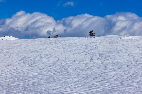 White clouds above snow covered field