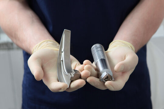 Laryngoscope for tracheal intubation in the hands of an anesthesiologist. General anesthesia before surgery. The concept of healthcare. Saving a life.