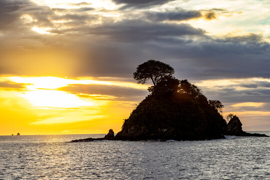 Silhouette of small island at sunset