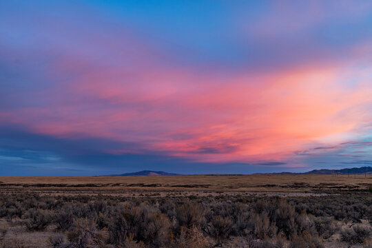 Dramatic sunrise sky above fields