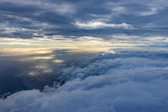 Clouds above Pacific Ocean from air at sunset