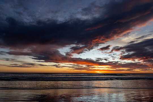 Dramatic sunset sky over calm ocean on Playa Grande