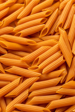 Uncooked chickpea penne pasta in a bowl 