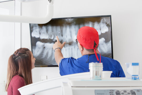Dentist explaining X-ray to female patient