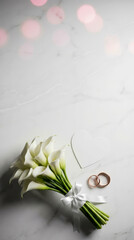 White calla lilies tied with a ribbon. Gold rings rest beside a heart-shaped cutout. Marble background with soft pink bokeh. Elegant wedding or engagement theme. Perfect for romantic, bridal