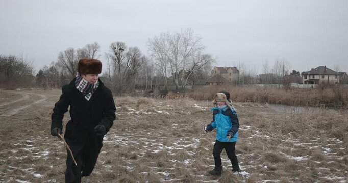 Man and kid boy go for walk. Dad and son play outside. 4K 10-bit