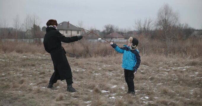 Man and kid boy go for walk. Dad and son play outside. 4K 10-bit