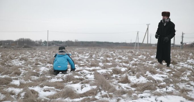 Man and kid boy go for walk. Dad and son play outside. 4K 10-bit