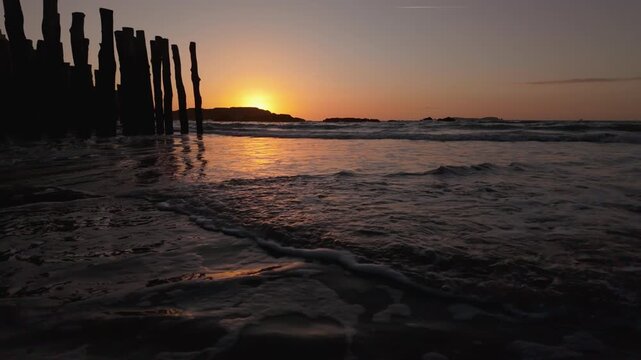 Wooden groynes of Saint-Malo at sunset