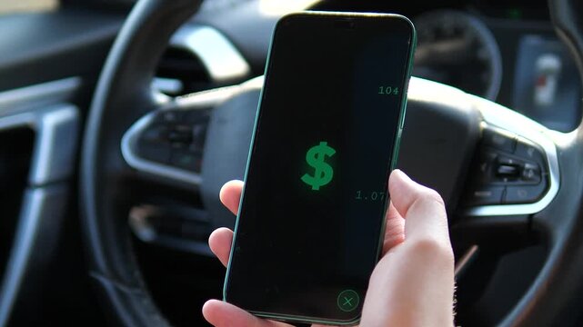 Hand holding smartphone in car showing dollar sign and rising numbers animation. Concept of passive income, mobile trading, and financial success. Great for ads about wealth and money-making apps