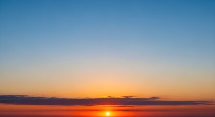 Obraz premium vibrant sunset with orange sun and blue sky