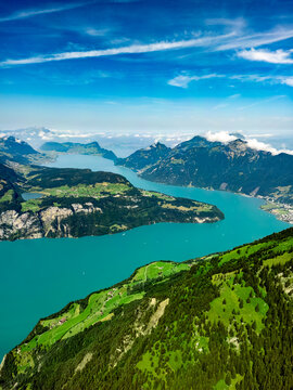 Aerial view of the dazzling turquoise waters of Lake Lucerne winding through verdant hillsides, a picturesque scene of natural beauty, Lucerne, Switzerland.