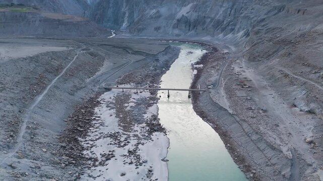 Aerial Forward Tilt Shot of Concrete Bridge Over Indus River in Jaglot 4K, Solitary Modern Bridge Spanning Arid Himalayan River Valley