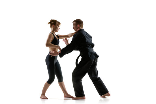 Woman pushing attacker away using self defense technique in realistic combat training. Concept of personal empowerment, boundary protection and confident reaction to physical threat.