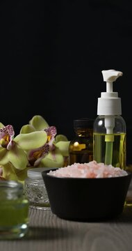 Arrangement of spa and beauty products on black background