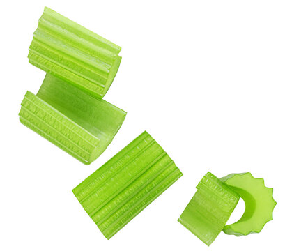 Falling chopped celery isolated on white background. Fresh celery pieces explotion. Flying celery  Top view. Flat lay