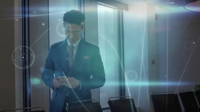 Manager pulling phone, scrolling in business meeting while HUD arcs rising around him, prepping