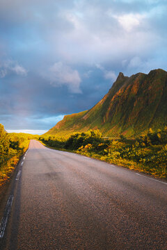 Empty road in Lofoten islands sunset mountains landscape in Norway scandinavian nature beautiful travel destination scenic route moody scenery