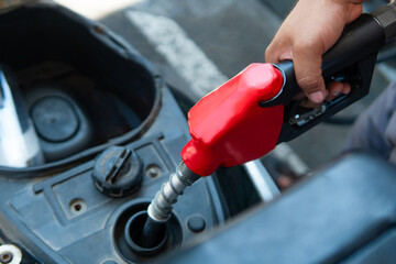 Hand fueling scooter tank during energy crisis © Djavan Rodriguez