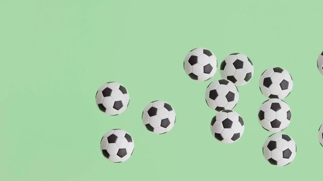 Soccer balls bouncing on a green background