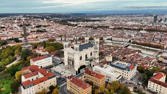 France, Lyon, Notre-Dame de Fourviere basilica, foreward drone aerial view. Saone river and Bellecour square in back.